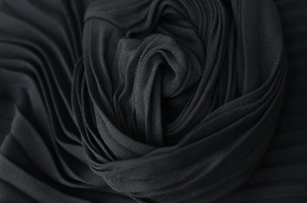 black pleated fabric placed on table